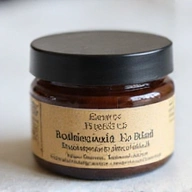 A small jar of 'Botanical Lip Balm' with a minimalist, earthy-toned label, showing shea butter and beeswax ingredients.